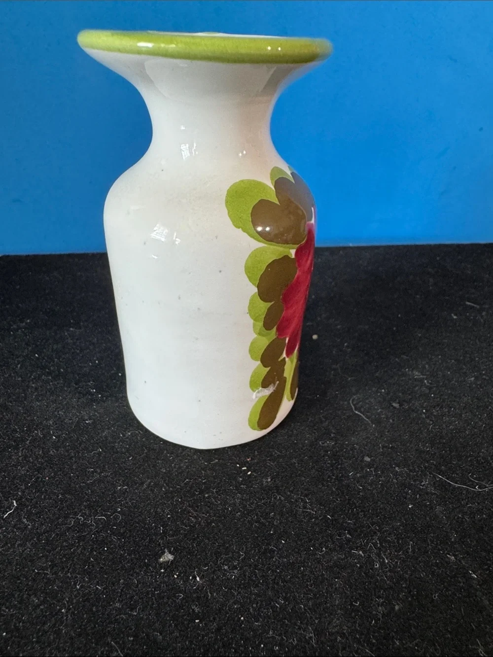 vintage ceramic vase features hand-painted floral motifs typical of mid-century